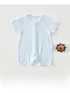 Flat lay of light blue ribbed short sleeve baby romper with a wooden lion toy prop