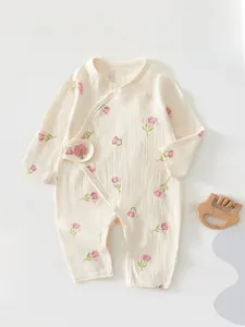 Detail of newborn long sleeve floral cotton romper with pink 3D flower and side snaps