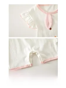 Detail of baby summer bodysuit featuring ruffled sleeves and resin snap buttons on bottom