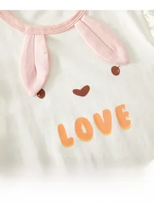 Close-up of baby bodysuit featuring pink bunny ears and orange LOVE print detail