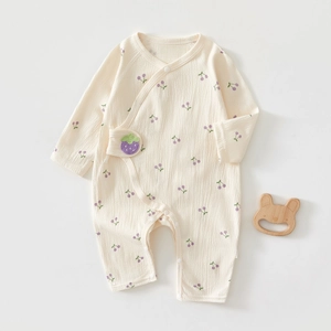 Detail of newborn cotton bodysuit with purple cherry print and berry embroidery
