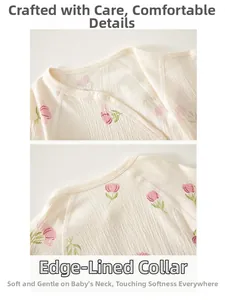 Detail of newborn baby romper featuring soft cotton crepe fabric and pink tulip pattern