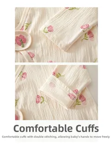 Close-up of double-stitched cuffs and floral pattern on newborn organic cotton kimono