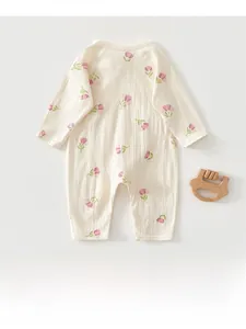 Close-up of newborn romper in cream with pink tulip print and soft cotton texture