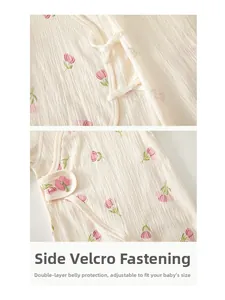 Detail of newborn cotton romper with adjustable velcro closure and tulip embroidery