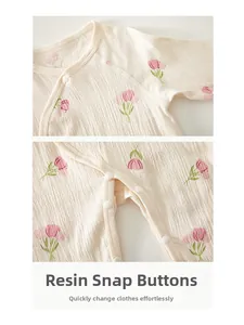 Detail view of newborn romper featuring tulip prints and durable resin snap buttons