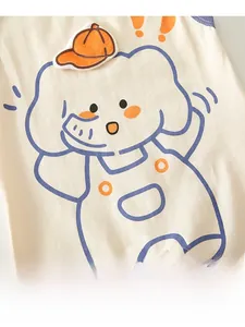 Close-up of cotton baby bodysuit with blue cartoon elephant and orange hat detail
