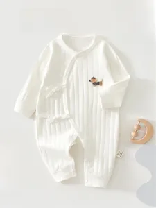 Detail of baby long sleeve romper with cute dog embroidery and soft ribbed cotton texture