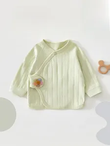Detail view of newborn long sleeve cotton shirt with soft ribbed texture and floral embroidery