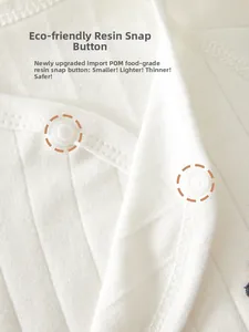 Macro detail of food-grade POM resin snaps on white ribbed cotton baby bodysuit