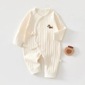 Detail of ribbed cotton baby romper with dachshund embroidery and side tie closure