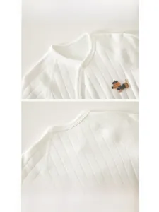 Close-up of ribbed cotton baby romper with dachshund embroidery and bound neckline