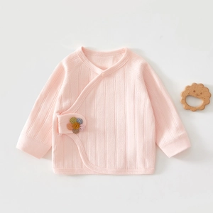 Close-up of pink long-sleeved newborn baby top with ribbed cotton and rainbow flower patch