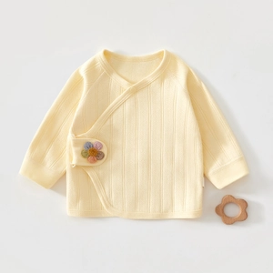 Detail of yellow ribbed cotton kimono top with colorful floral embroidery for newborns