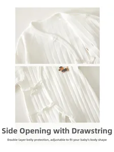 Detailed view of white cotton baby romper featuring side-tie closure and puppy embroidery
