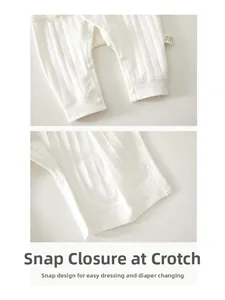 Detail of baby romper snap closure and ribbed cotton fabric for easy diaper changes