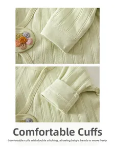 Detail of comfortable knitted cuffs on cotton newborn shirt with floral embroidery
