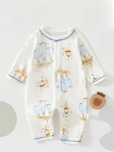Detail of baby cotton romper with cartoon hot air balloon and bear patterns and blue edges