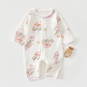 Flat lay detail of a floral long-sleeved baby romper with cute mushroom and flower patterns