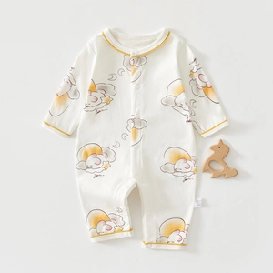 Detail of baby cotton romper with cartoon sheep print and woven size label
