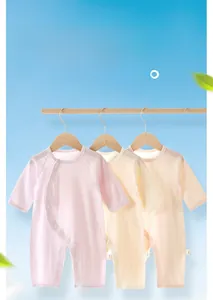 Detailed view of lightweight cotton baby bodysuits in soft pastel colors with snaps
