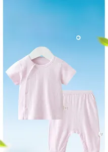Detail of baby pink cotton set with breathable hollow jacquard texture and side buttons