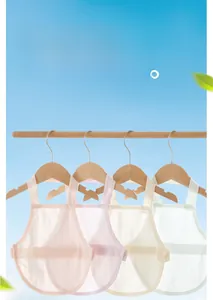 Detail view of breathable mesh baby belly wraps in various pastel colors on wooden hangers