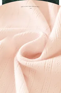 Close-up of 100% pure cotton baby fabric with soft breathable hollow knit texture