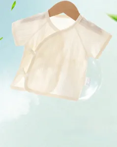Close-up of pointelle knit newborn cotton tie-front kimono with short sleeves