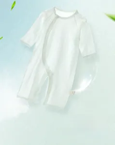 Detail of white cotton baby romper with breathable vertical stripes and side snaps