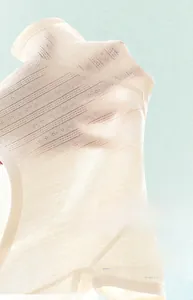 Breathable macro mesh texture of newborn cotton top showing sweat-wicking airflow