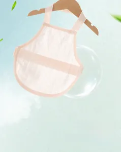 Close-up of breathable baby pink cotton belly band on a wooden hanger with soft lighting