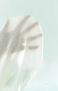 Detailed macro view of the breathable white mesh cotton fabric with hollow knit pattern