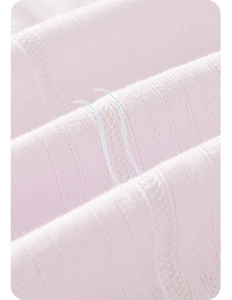 Close-up of pink breathable pointelle knit cotton fabric for baby rompers