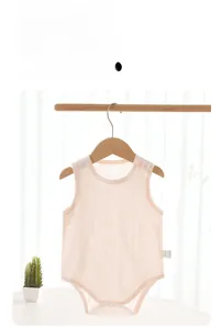 Close-up of pink baby bodysuit details including snap buttons and breathable cotton fabric