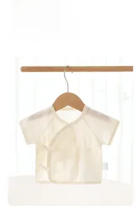 Detail of newborn cotton short sleeve top with breathable hollow knit and ribbon ties