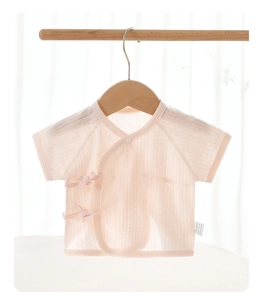 Close-up of pink cotton newborn short sleeve wrap top with tie closure and soft texture