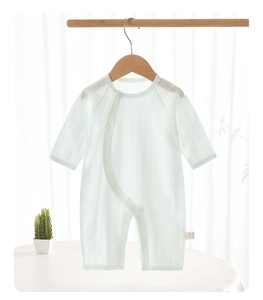 Close-up of ribbed cotton baby romper fabric with side snap buttons and a small label