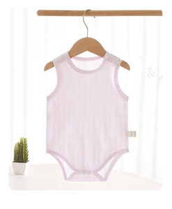 Detailed view of pink sleeveless cotton baby bodysuit with snap buttons on a wooden hanger