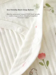 Détail de pressions en résine écologique sur un body fleuri pour nouveau-né