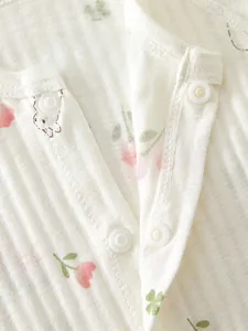 Detail of eco-friendly resin snap buttons on cotton ribbed fabric with floral print