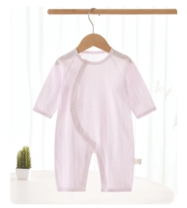 Detail of baby pink ribbed cotton romper with side snap buttons and hanging design