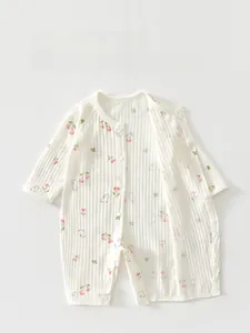 Detail of baby cotton romper with pink floral and rabbit print featuring snap buttons