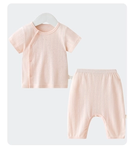 Detail of pink cotton baby set featuring breathable mesh texture and side snap buttons