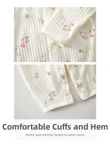 Detailed macro view of the double-stitched sleeve cuffs on this ribbed cotton baby bodysuit