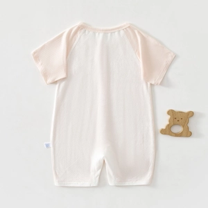 Detail view of baby summer bodysuit with breathable mesh fabric and soft pink raglan sleeves