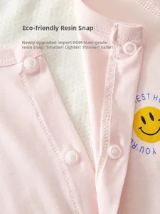 Detail of baby onesie showing secure pink fabric and eco-friendly resin snap buttons