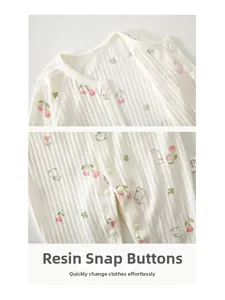 Detail of high-quality resin snaps on soft cotton baby romper with floral tulip print