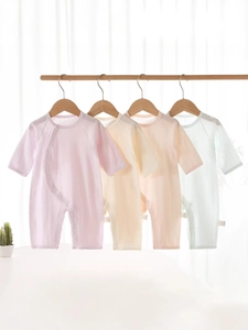 Infant cotton long sleeve romper in pastel colors hanging on wooden hangers