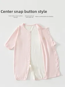 Detail view of pink baby bodysuit showing breathable mesh lining and snap button closure